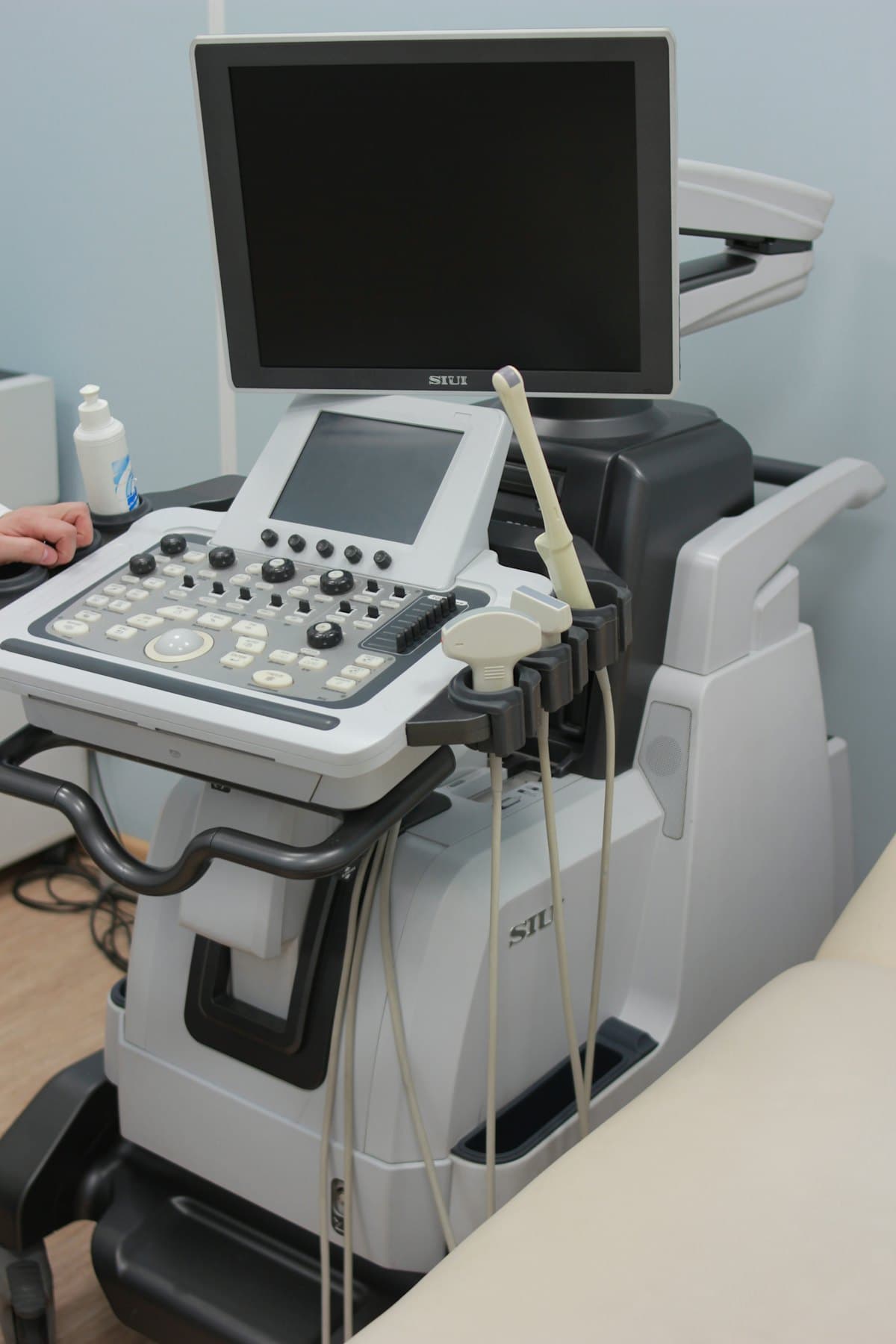 An ultrasound machine with monitor in an examination room