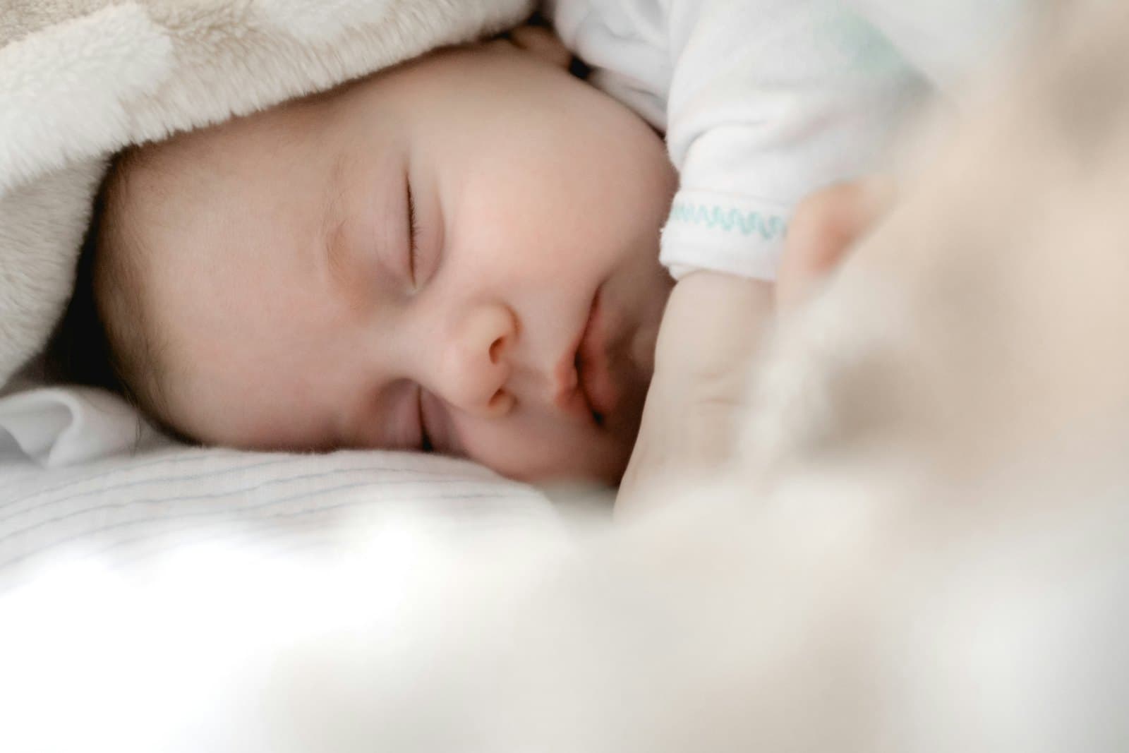 A newborn baby sleeping peacefully wrapped in a soft blanket